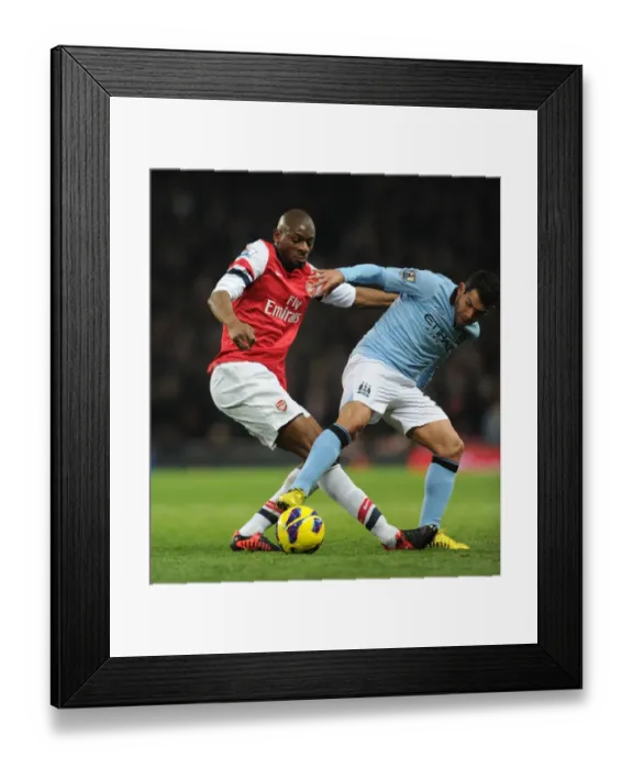 Framed Print : Abou Diaby vs. Carlos Tevez: Intense Tackle in Arsenal vs. Manchester City Premier League Clash (2012-13)