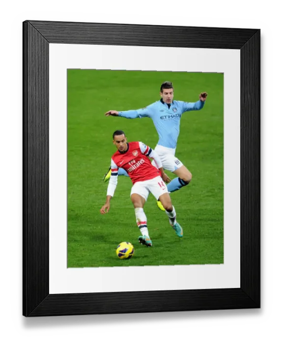 Framed Print : Arsenal's Theo Walcott Fends Off Manchester City's Matija Nastasic in Premier League Clash