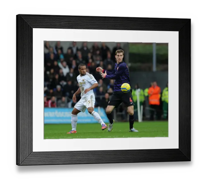 Framed Print : Per Mertesacker vs Wayne Routledge: Intense Battle in Swansea City vs Arsenal FA Cup Clash