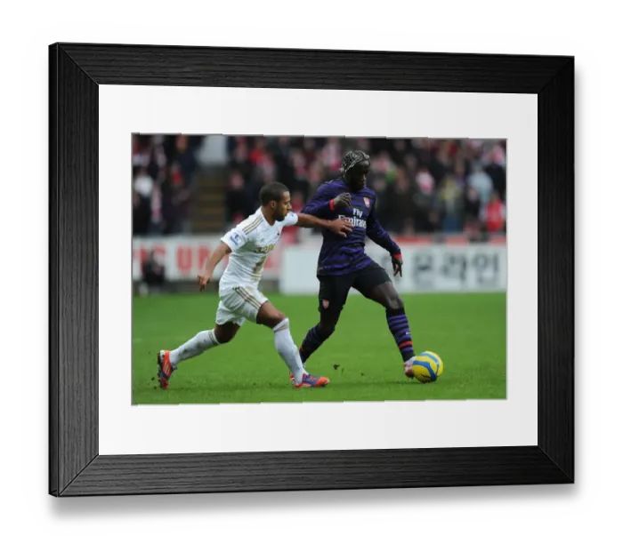Framed Print : Bacary Sagna Outmaneuvers Wayne Routledge in Swansea v Arsenal FA Cup Clash