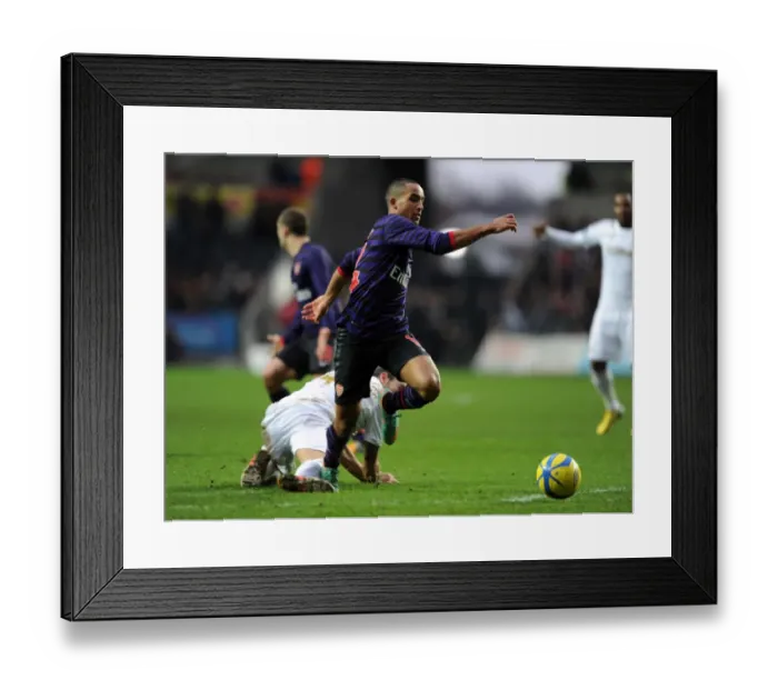 Framed Print : Theo Walcott vs Chico Flores: A FA Cup Battle at Swansea Framed Print : Theo Walcott vs Chico Flores: A FA Cup Battle at Swansea