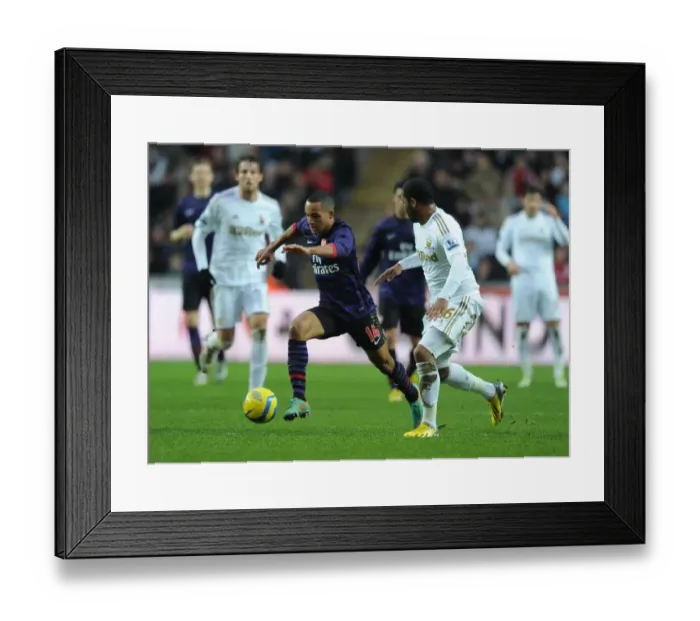 Framed Print : Theo Walcott Outmaneuvers Kemy Agustien in Swansea v Arsenal FA Cup Clash Framed Print : Theo Walcott Outmaneuvers Kemy Agustien in Swansea v Arsenal FA Cup Clash