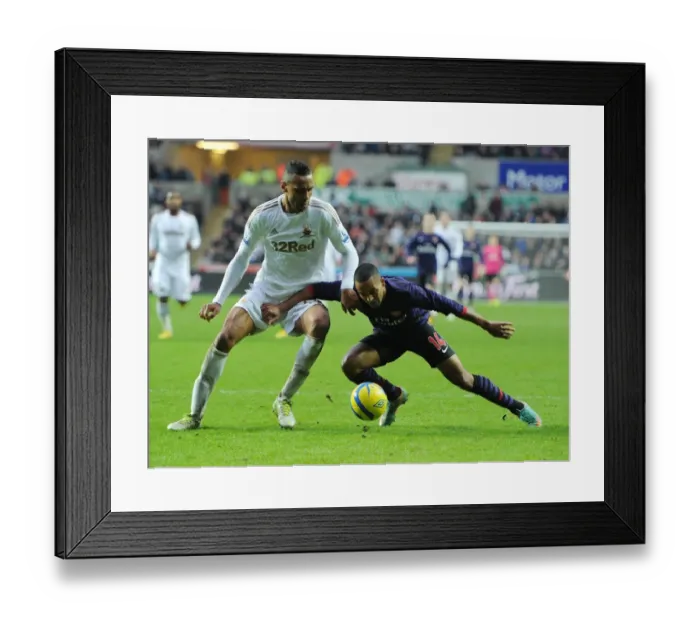 Framed Print : Theo Walcott vs. Kyle Bartley: A FA Cup Battle at Swansea Framed Print : Theo Walcott vs. Kyle Bartley: A FA Cup Battle at Swansea