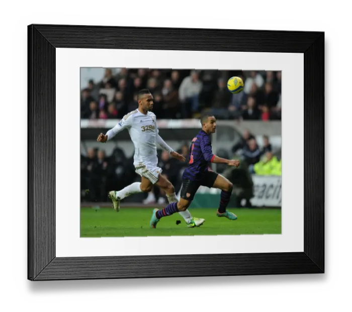 Framed Print : Theo Walcott Outpaces Kyle Bartley in FA Cup Clash: Swansea vs Arsenal (2012-13) Framed Print : Theo Walcott Outpaces Kyle Bartley in FA Cup Clash: Swansea vs Arsenal (2012-13)