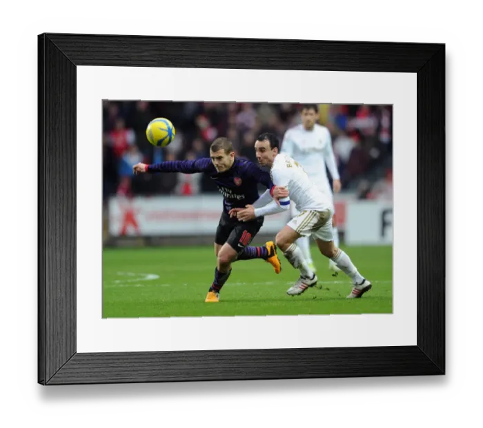 Framed Print : Battle of Midfield: Jack Wilshere vs. Leon Britton - FA Cup Showdown, 2013: Arsenal's Wilshere Outmaneuvers Swansea's Britton Framed Print : Battle of Midfield: Jack Wilshere vs. Leon Britton - FA Cup Showdown, 2013: Arsenal's Wilshere Outmaneuvers Swansea's Britton