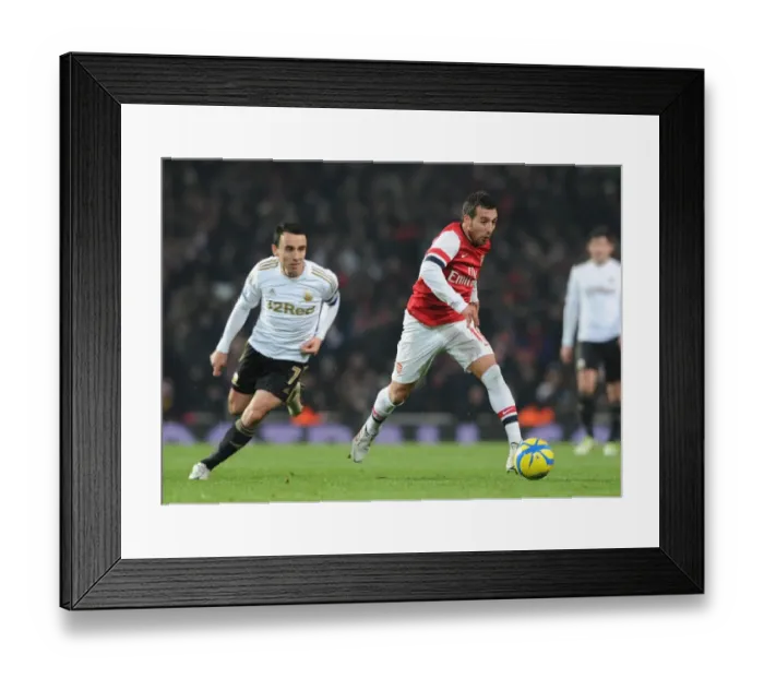 Framed Print : Arsenal's Santi Cazorla Dashes Past Swansea's Leon Britton in FA Cup Third Round Replay Framed Print : Arsenal's Santi Cazorla Dashes Past Swansea's Leon Britton in FA Cup Third Round Replay