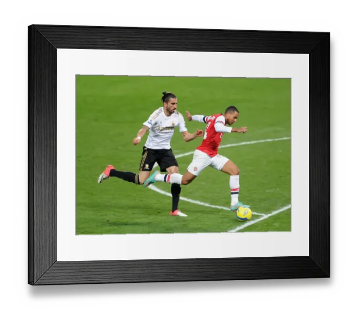 Framed Print : Theo Walcott (Arsenal) Chico Flores (Swansea). Arsenal 1: 0 Swansea City. FA Cup 3rd Round replay