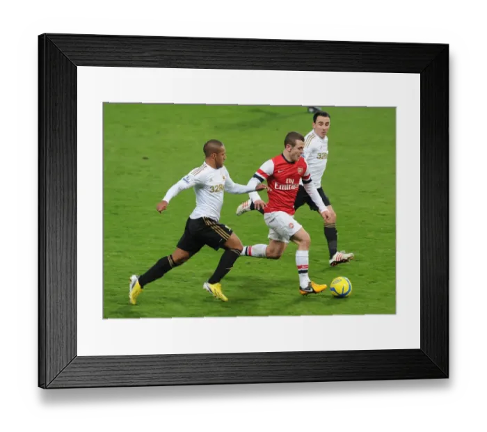 Framed Print : Arsenal's Jack Wilshere Goes Head-to-Head with Swansea's Ashley Richards and Leon Britton in FA Cup Clash Framed Print : Arsenal's Jack Wilshere Goes Head-to-Head with Swansea's Ashley Richards and Leon Britton in FA Cup Clash