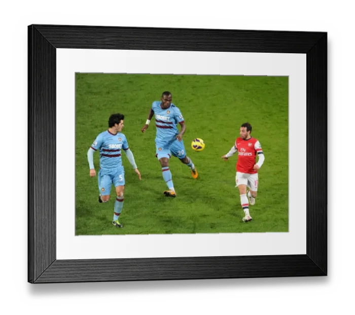 Framed Print : Santi Cazorla vs. Guy Demel and James Tomkins: Intense Battle at Arsenal v West Ham United (2013)