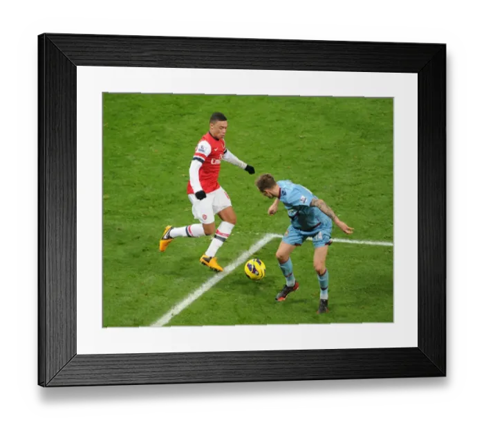 Framed Print : Arsenal's Alex Oxlade-Chamberlain Charges Past West Ham's Matt Taylor