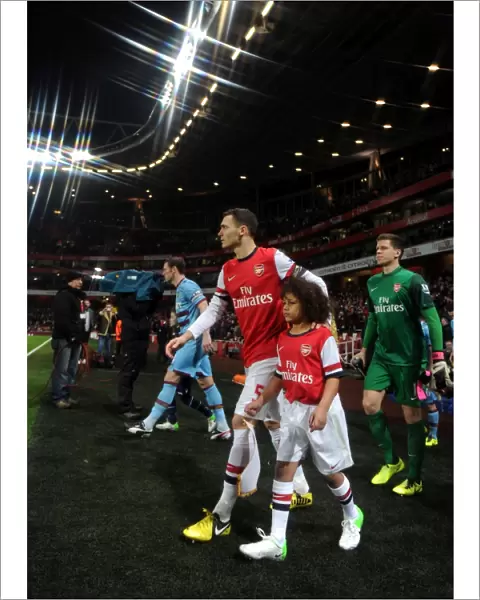 Thomas Vermaelen (Arsenal) walks out onto the pitch with the mascot. Arsenal 5: 1 West Ham United