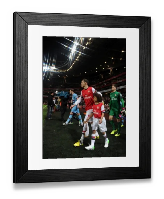 Framed Print : Thomas Vermaelen (Arsenal) walks out onto the pitch with the mascot. Arsenal 5: 1 West Ham United Framed Print : Thomas Vermaelen (Arsenal) walks out onto the pitch with the mascot. Arsenal 5: 1 West Ham United