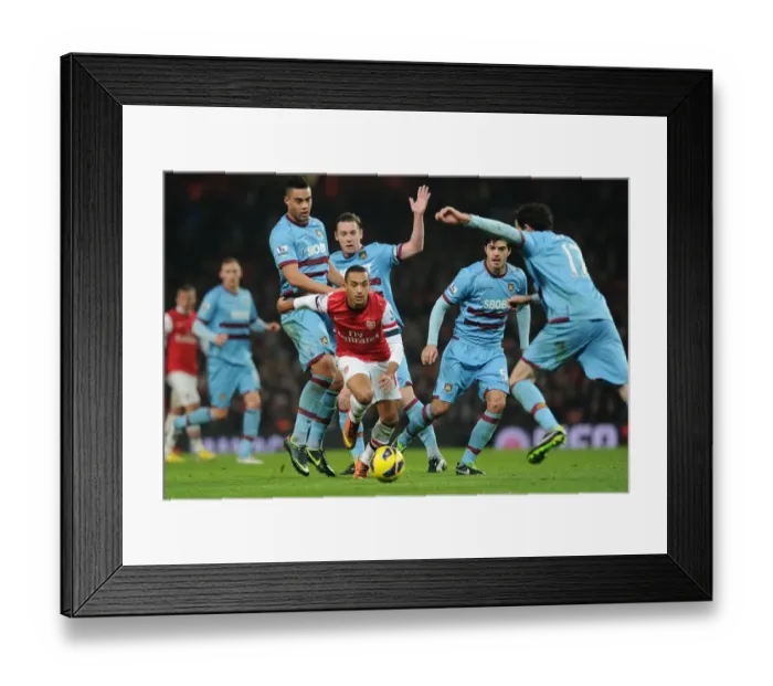 Framed Print : Theo Walcott vs. The West Ham United Defenders: A Battle at the Emirates