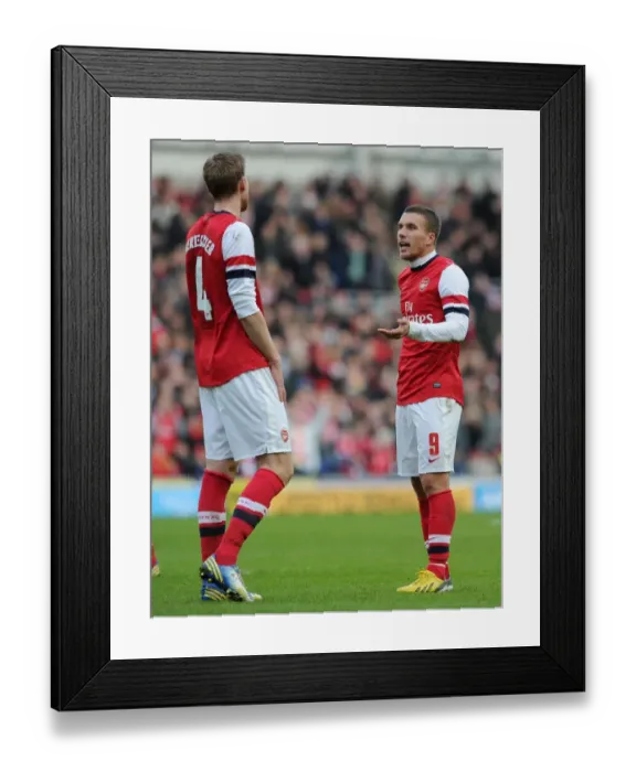 Framed Print : Podolski and Mertesacker in Deep Conversation: Brighton vs Arsenal, FA Cup 2012-13