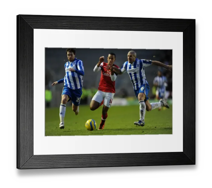 Framed Print : Theo Walcott vs. Wayne Bridge and Adam El-Abd: A Tense FA Cup Showdown - Arsenal's Star Forward Clashes with Brighton's Defenders Framed Print : Theo Walcott vs. Wayne Bridge and Adam El-Abd: A Tense FA Cup Showdown - Arsenal's Star Forward Clashes with Brighton's Defenders
