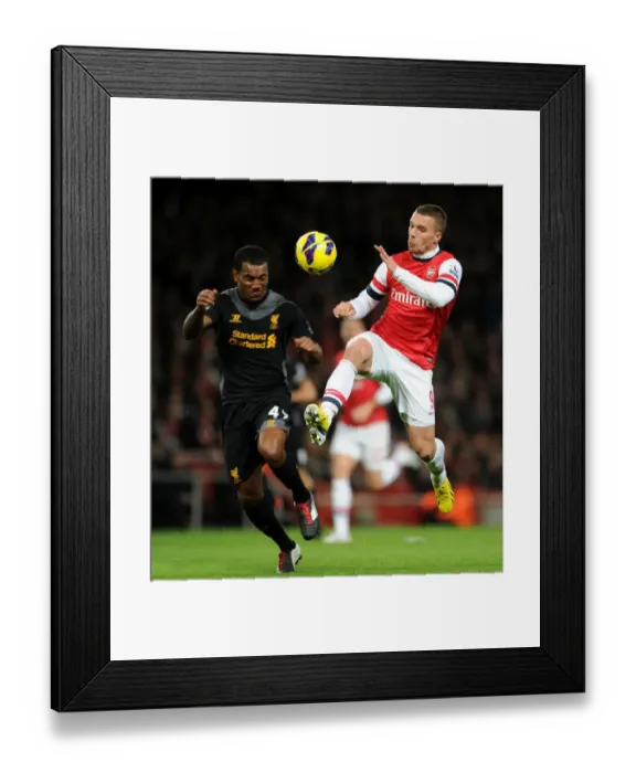 Framed Print : Arsenal vs. Liverpool: Podolski vs. Wisdom - Premier League Clash at Emirates Stadium
