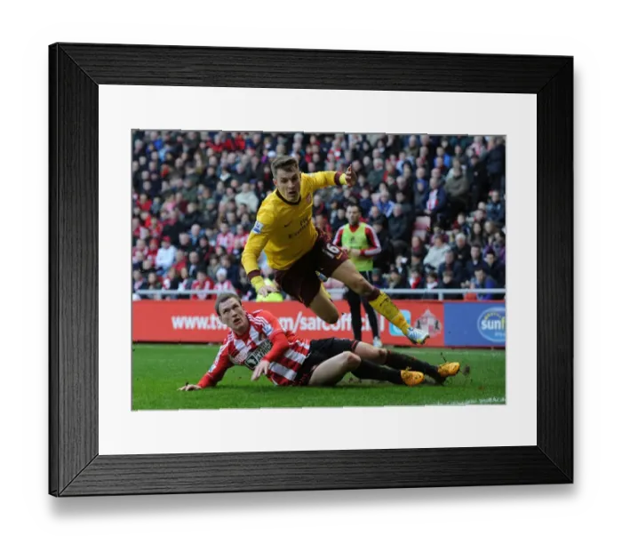 Framed Print : Aaron Ramsey vs. Craig Gardner: Intense Battle in Sunderland v Arsenal Premier League Clash Framed Print : Aaron Ramsey vs. Craig Gardner: Intense Battle in Sunderland v Arsenal Premier League Clash