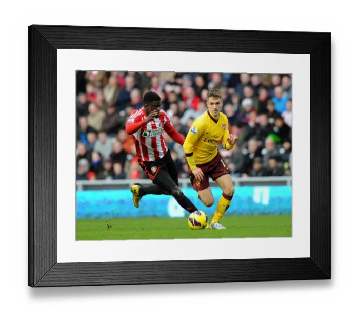 Framed Print : Aaron Ramsey (Arsenal) Alfred N Diaye (Sunderland). Sunderland 0: 1 Arsenal. Barclays Premier League Framed Print : Aaron Ramsey (Arsenal) Alfred N Diaye (Sunderland). Sunderland 0: 1 Arsenal. Barclays Premier League