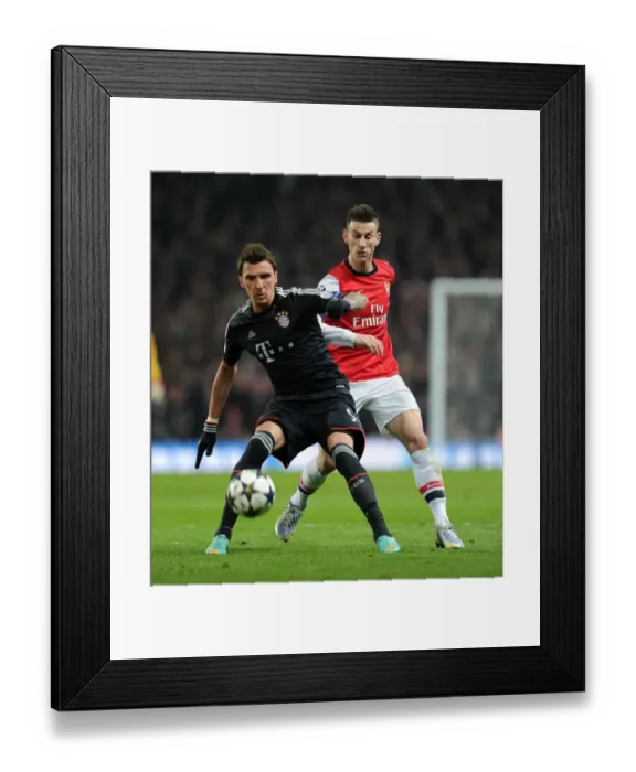 Framed Print : Koscielny vs. Mandzukic: A Champions League Battle at the Emirates