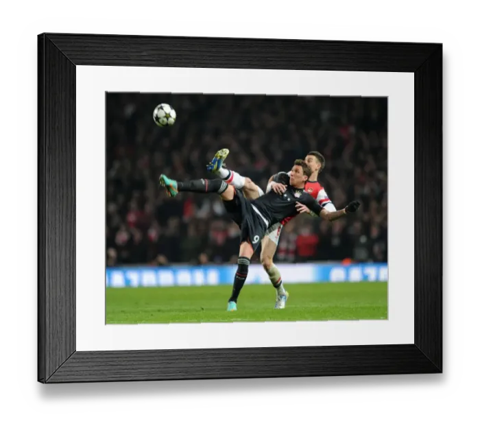 Framed Print : Intense Battle: Koscielny vs. Mandzukic in Arsenal's Champions League Showdown against Bayern Munich Framed Print : Intense Battle: Koscielny vs. Mandzukic in Arsenal's Champions League Showdown against Bayern Munich