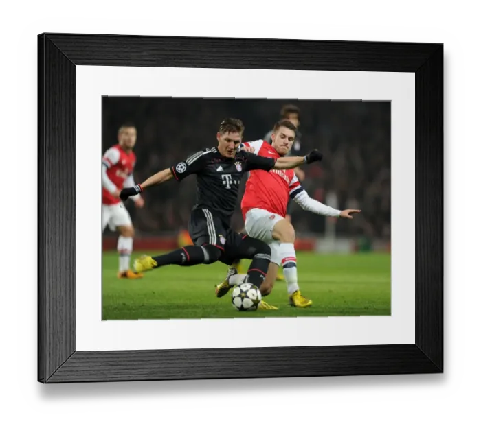 Framed Print : Arsenal's Aaron Ramsey Tackles Bastian Schweinsteiger in Intense Arsenal v Bayern Munich UCL Clash