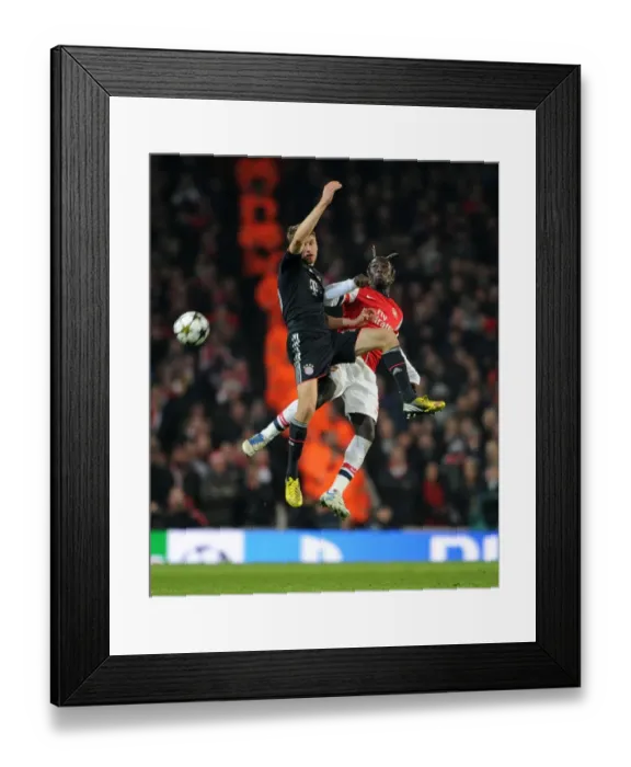 Framed Print : Clash of Titans: Sagna vs Muller in Arsenal vs Bayern Munich UEFA Champions League Showdown Framed Print : Clash of Titans: Sagna vs Muller in Arsenal vs Bayern Munich UEFA Champions League Showdown