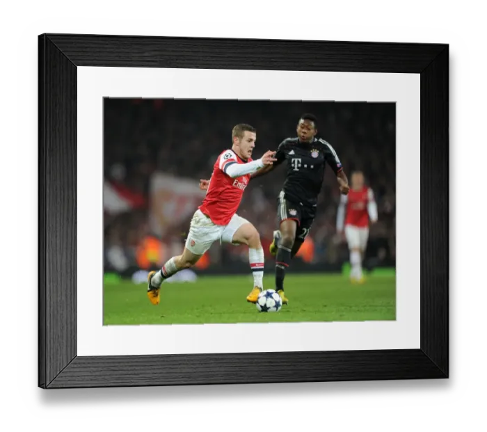 Framed Print : Arsenal's Jack Wilshere Clashes with Bayern Munchen's David Alaba in Champions League Showdown
