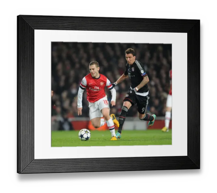 Framed Print : Arsenal's Jack Wilshere Clashes with Bayern's Mario Mandzukic in Champions League Showdown