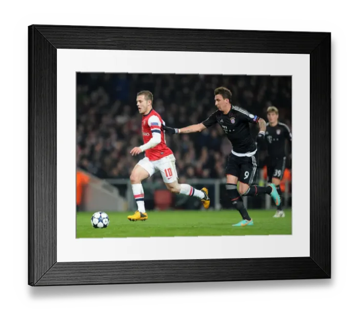 Framed Print : Clash of Stars: Jack Wilshere vs. Mario Mandzukic in Intense Arsenal-Bayern Champions League Showdown Framed Print : Clash of Stars: Jack Wilshere vs. Mario Mandzukic in Intense Arsenal-Bayern Champions League Showdown