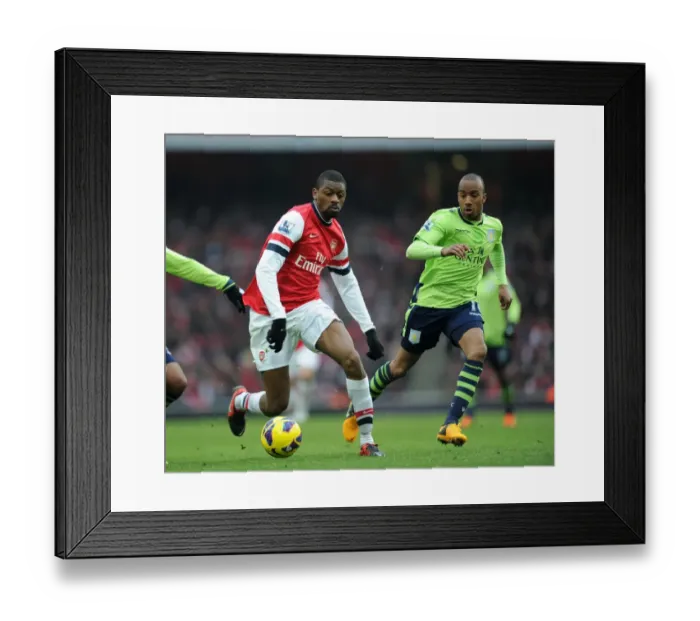 Framed Print : Arsenal's Abou Diaby Clashes with Aston Villa's Fabian Delph in Premier League Showdown