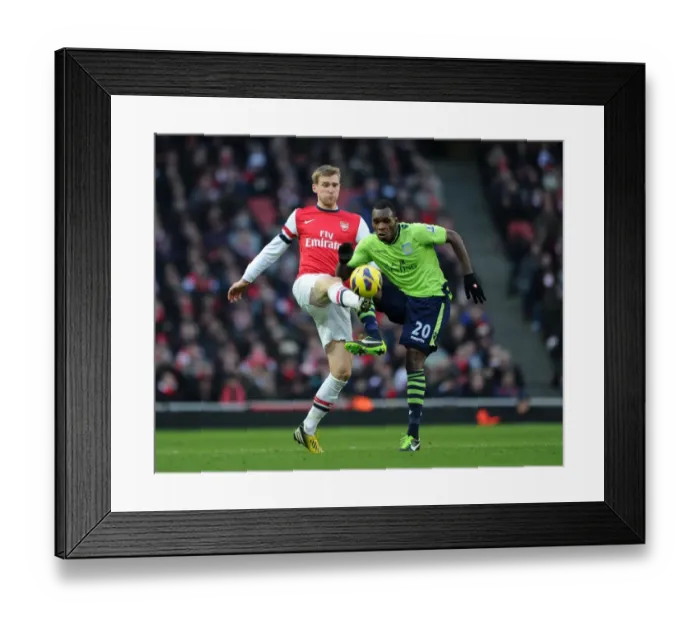 Framed Print : Arsenal's Per Mertesacker Wins Ball from Aston Villa's Christian Benteke in Premier League Clash