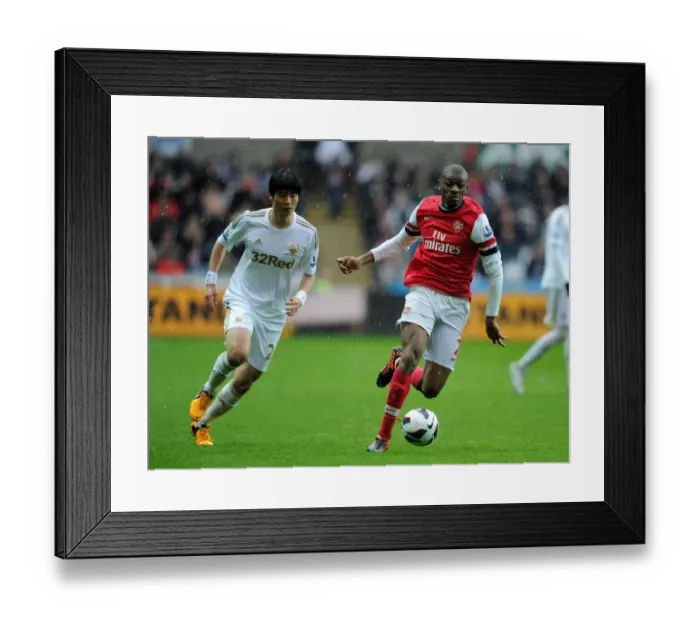 Framed Print : Abou Diaby Outmaneuvers Ki Sung-Yueng: A Premier League Battle at Swansea, 2012-2013 Framed Print : Abou Diaby Outmaneuvers Ki Sung-Yueng: A Premier League Battle at Swansea, 2012-2013