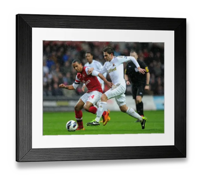 Framed Print : Theo Walcott vs. Angel Rangel: Intense Battle in Swansea City vs. Arsenal Premier League Clash Framed Print : Theo Walcott vs. Angel Rangel: Intense Battle in Swansea City vs. Arsenal Premier League Clash