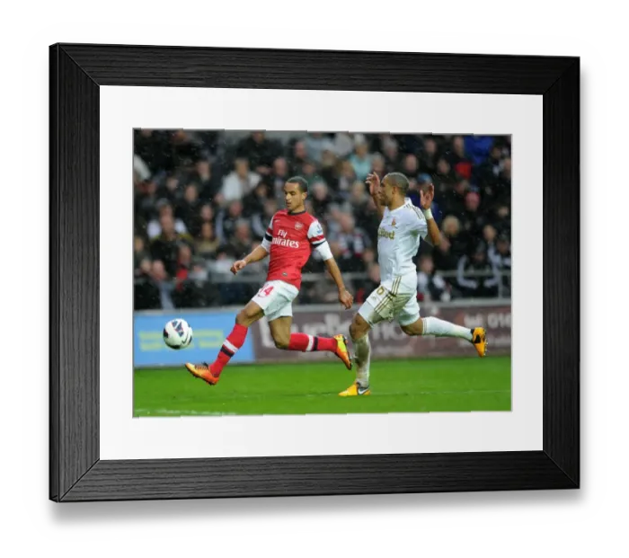 Framed Print : Theo Walcott vs Ashley Williams: Intense Battle at Swansea City's Liberty Stadium (Arsenal vs Swansea, Premier League 2012-13)