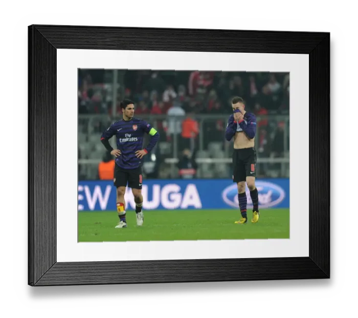 Framed Print : Dejected Arsenal: Mikel Arteta and Laurent Koscielny After UEFA Champions League Defeat to Bayern Munich
