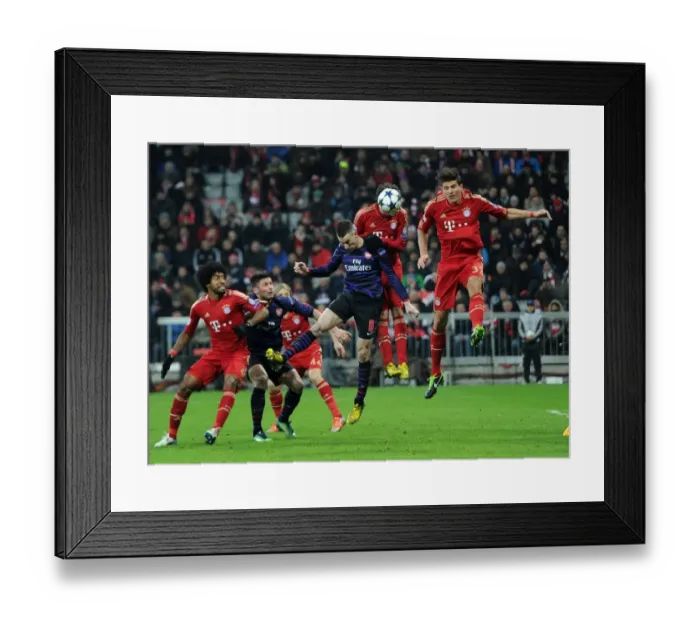Framed Print : Laurent Koscielny's Headed Goal: Arsenal's Momentum Shift Against Bayern Munich in the 2012-13 UEFA Champions League