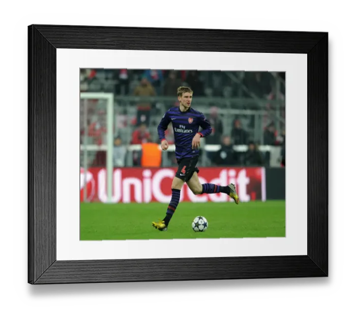 Framed Print : Per Mertesacker (Arsenal). Bayern Munich 0: 2 Arsenal. UEFA Champions League. Round of 16