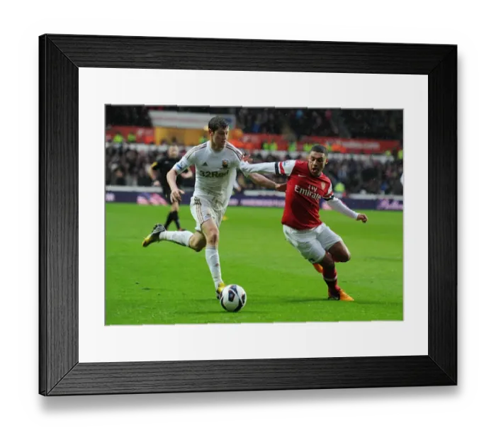 Framed Print : Alex Oxlade-Chamberlain Surges Past Ben Davies in Swansea vs Arsenal Premier League Clash Framed Print : Alex Oxlade-Chamberlain Surges Past Ben Davies in Swansea vs Arsenal Premier League Clash