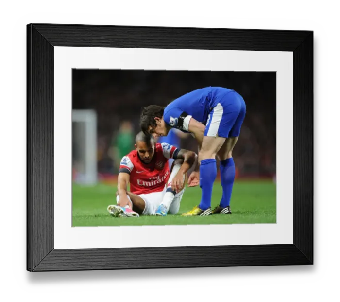 Framed Print : Theo Walcott and Leighton Baines: A Moment of Respite Amidst the Arsenal v Everton Rivalry Framed Print : Theo Walcott and Leighton Baines: A Moment of Respite Amidst the Arsenal v Everton Rivalry