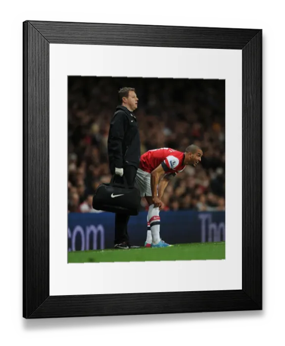 Framed Print : Theo Walcott's Injury: Colin Lewin Tends to Arsenal Star during Arsenal v Everton Match (2012-13)