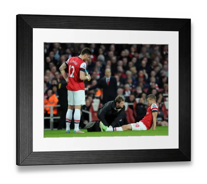Framed Print : Arsenal: Jack Wilshere Receives Treatment from Colin Lewin as Olivier Giroud Looks On during Arsenal v Everton (2013)