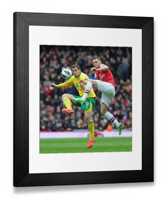 Framed Print : Thomas Vermaelen vs Grant Holt: Battle for the Ball - Arsenal vs Norwich City, Premier League 2012-13 Framed Print : Thomas Vermaelen vs Grant Holt: Battle for the Ball - Arsenal vs Norwich City, Premier League 2012-13
