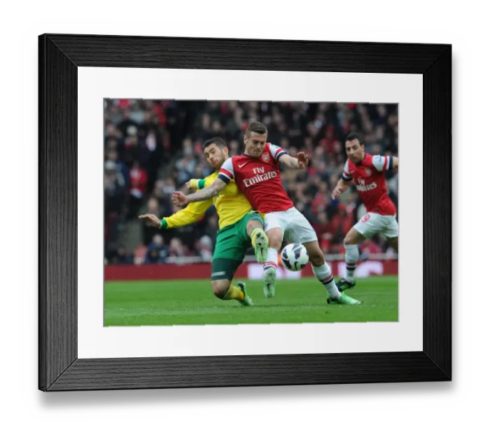 Framed Print : Arsenal's Jack Wilshere Faces Off Against Norwich's Bradley Johnson in Premier League Clash