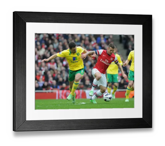 Framed Print : Arsenal's Jack Wilshere Fends Off Norwich's Russell Martin during the 2013 Premier League Clash
