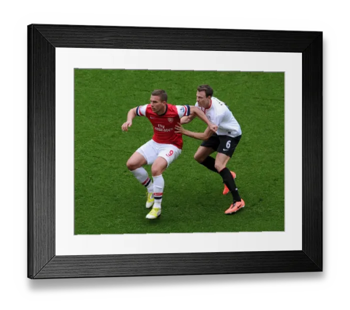Framed Print : Lukas Podolski (Arsenal) Jonny Evans (Man Utd). Arsenal 1: 1 Manchester United. Barclays