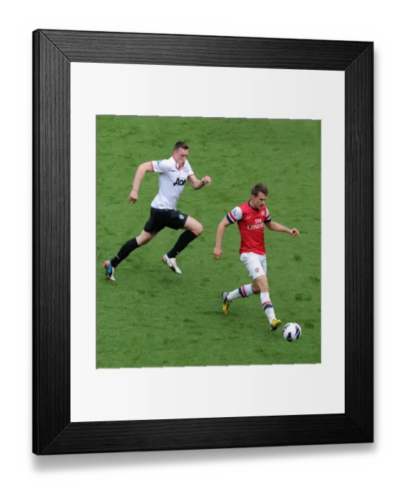 Framed Print : Aaron Ramsey (Arsenal) Phil Jones (Man Utd). Arsenal 1: 1 Manchester United. Barclays Premier League Framed Print : Aaron Ramsey (Arsenal) Phil Jones (Man Utd). Arsenal 1: 1 Manchester United. Barclays Premier League