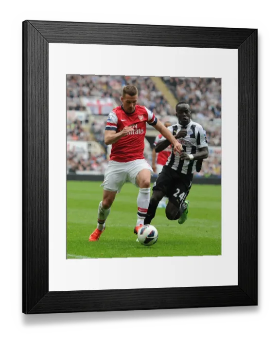 Framed Print : Lukas Podolski Breaks Past Cheik Tiote: Newcastle United vs. Arsenal, Premier League 2012-13 Framed Print : Lukas Podolski Breaks Past Cheik Tiote: Newcastle United vs. Arsenal, Premier League 2012-13
