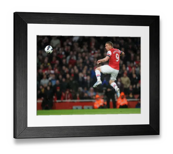 Framed Print : Lukas Podolski scores his 2nd goal Arsenals 3rd. Arsenal 4: 1 Wigan Athletic. Barclays Framed Print : Lukas Podolski scores his 2nd goal Arsenals 3rd. Arsenal 4: 1 Wigan Athletic. Barclays
