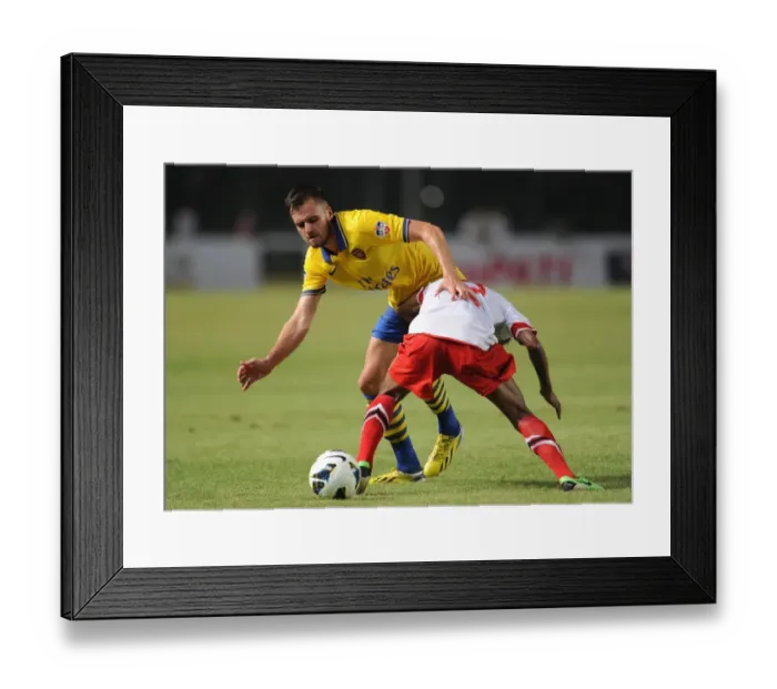 Framed Print : Clash of Stars: Jenkinson vs. Sanadi in Arsenal's Encounter with Indonesia All-Stars