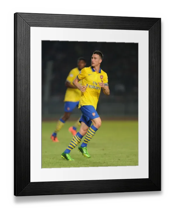 Framed Print : Laurent Koscielny: Arsenal Star Shines in Indonesia Dream Team Match, 2013